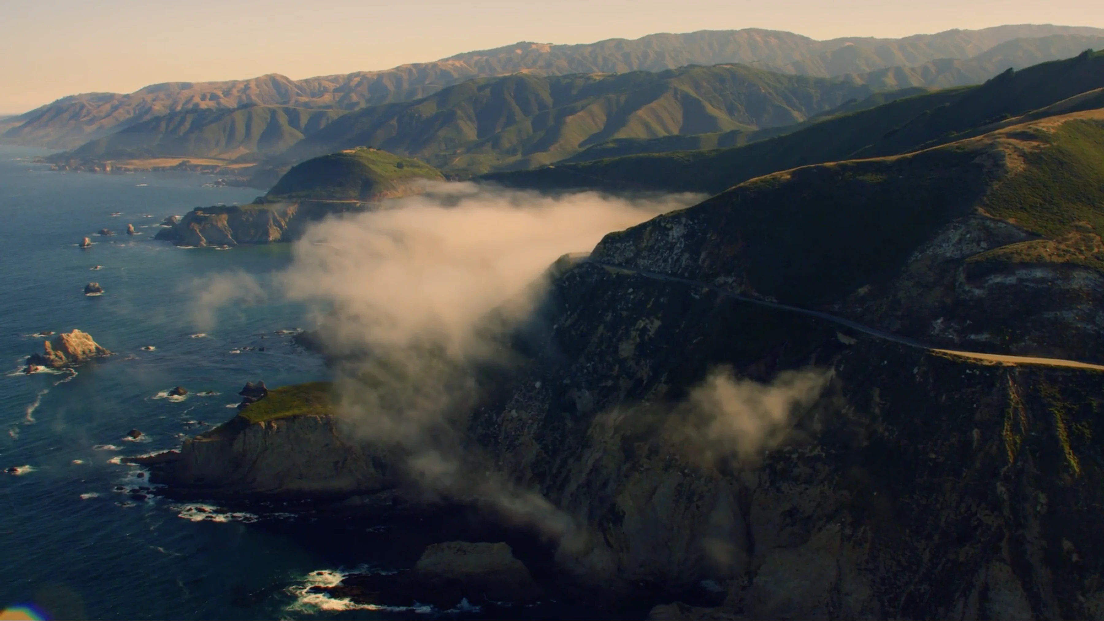 Mist rolling over the cliffs and Highway One